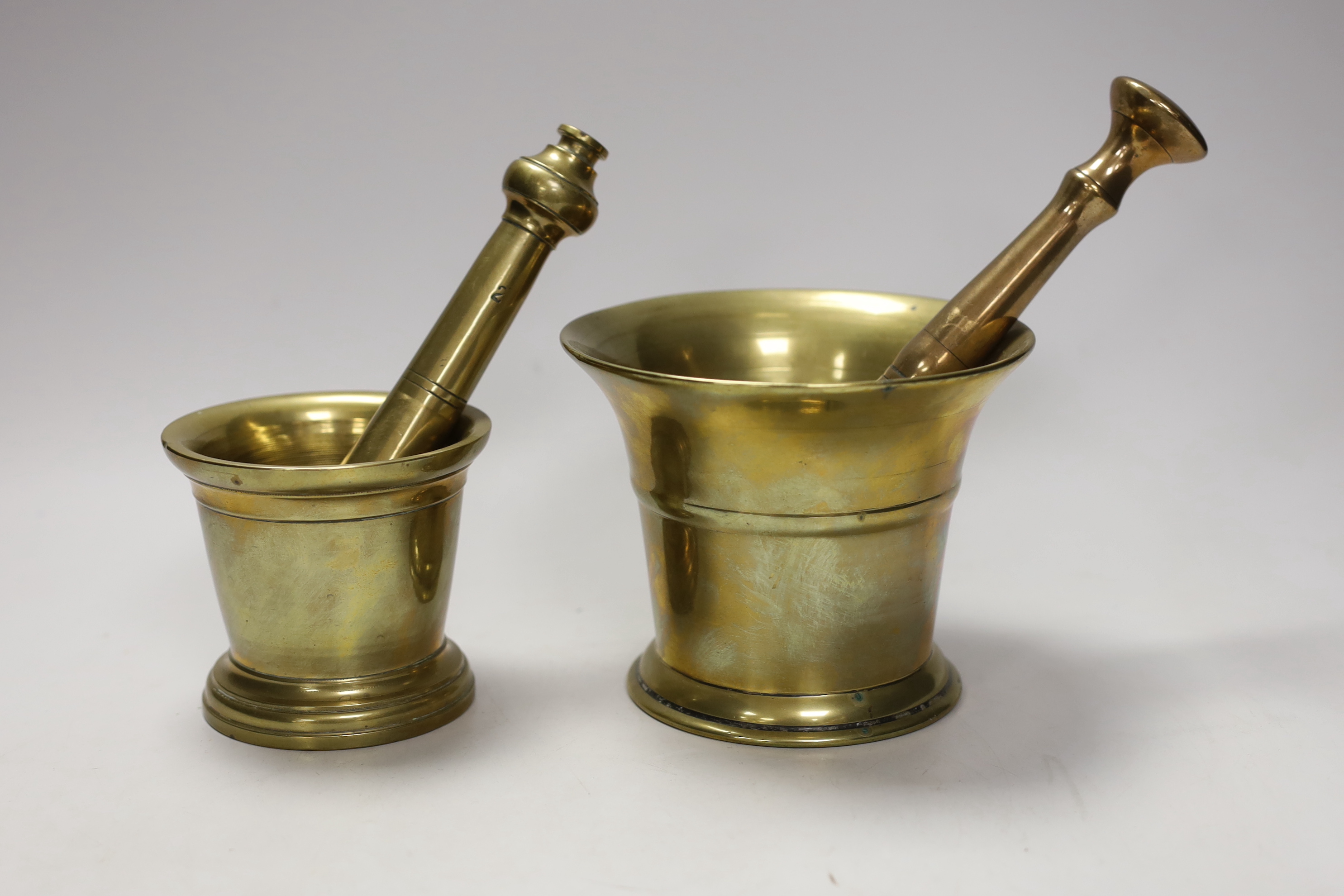 Two brass pestle and mortars, largest mortar 11.5cm tall